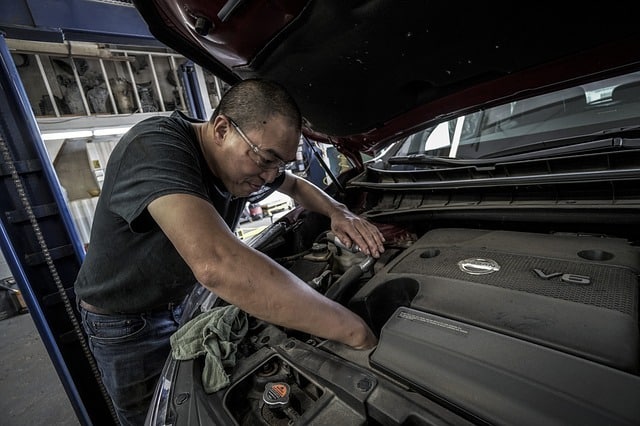 Photo of an auto mechanic under the hood of a car in an article on studying God's word on the Church of Christ Santa Clara SCCOC truthseekers.org website.